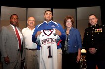 Rockhurst High School senior offensive tackle Zach Hannon was presented a jersey and formally selected to attend the second annual Semper Fidelis All-American Bowl game by Capt. Landon Dunaway, the operations officer of Recruiting Station Kansas City, at the Memorial Hall in the National World War I Museum, Dec. 11. Hannon is ranked 19th best offensive guard in the U.S. by www.Rivals.com.