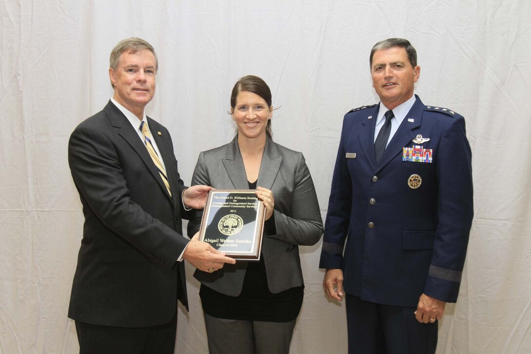 (Left) Ralph Tice, Class of 1974, then (now former) president of The Citadel Alumni Association, and Lt. Gen. John W. Rosa (right), Class of 1973 and president of The Citadel (center) present Former Marine Reserve Capt. Abigail R. Zuehlke with a plaque to signify her induction into the Arland D. Williams Society Nov. 11, 2011. Zuehlke, 31, rescued a Marine and his brother from drowning in a fierce rip current at Hunting Island State Park, S.C., July 8, 2011. Zuehlke has since been a Navy and Marine Corps Achievement Medal for her heroic actions. Zuehlke is currently assigned to the Inactive Ready Reserve, Marine Forces Reserve. (Photo courtesy of Russ Pace/Citadel Photographer)