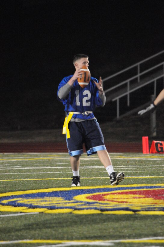 Justin Topping, quarterback for Marine Helicopter Squadron 1's American League intramural flag football team, falls back into the pocket while scanning for an open reciever during the championship game at Butler Stadium on Dec. 10.