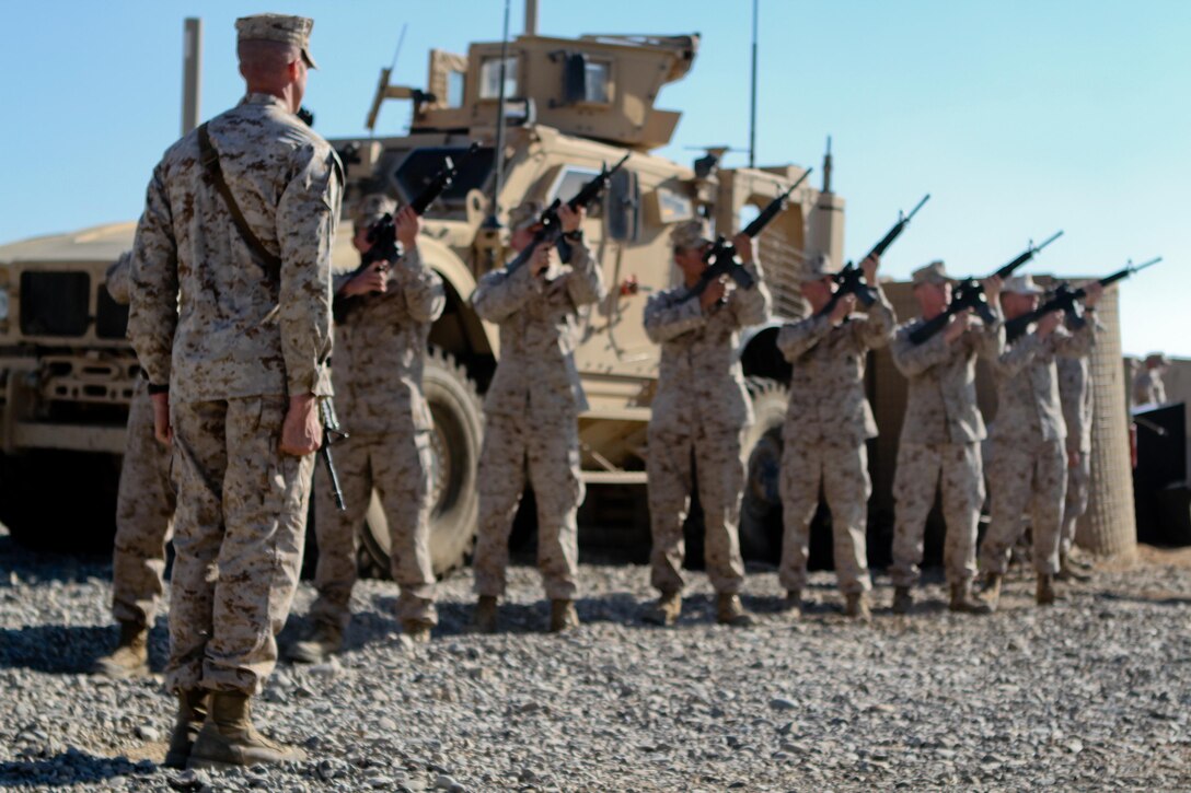 Staff Sgt. James Woolford, left, platoon sergeant, India Company, 3rd Battalion, 9th Marine Regiment, Regimental Combat Team 7, leads the firing detail during their three-volley salute during a memorial service honoring Lance Cpl. Anthony Denier, Dec. 8, 2012. Denier, a rifleman with the battalion, died while conducting combat operations in Marjah, Afghanistan, Dec. 2, 2012.