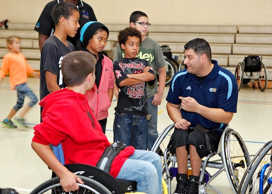 Michael Garafola, UCLA Adaptive Recreation volunteer, was one of the many ambassadors with the Triumph Foundation who were on hand to teach Edwards Youth Center members about adaptive sports during an an adapted sports clinic Dec. 6, 2012. (U.S. Air Force photo by Jet Fabara)