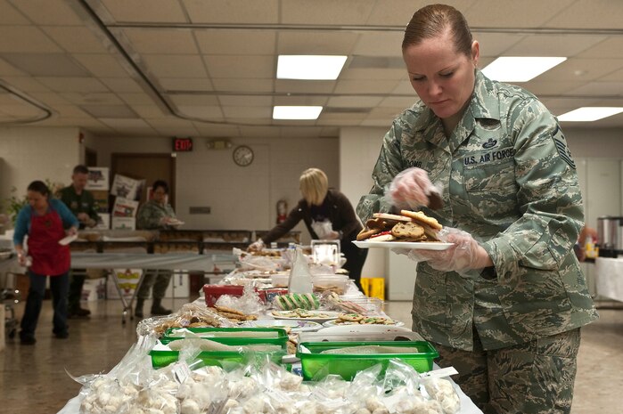 Master Sgt. Kara Barcomb, 757th Aircraft Maintenance Squadron Eagle Aircraft Maintenance Unit first sergeant, places an assortment of cookies on a plate to be placed in a bag during the Cookie Drive Dec. 11, 2012, at Nellis Air Force Base, Nev. Cookies were collected, assorted, and placed in bags for dissemination during the event. (U.S. Air Force photo by Staff Sgt. Christopher Hubenthal)

