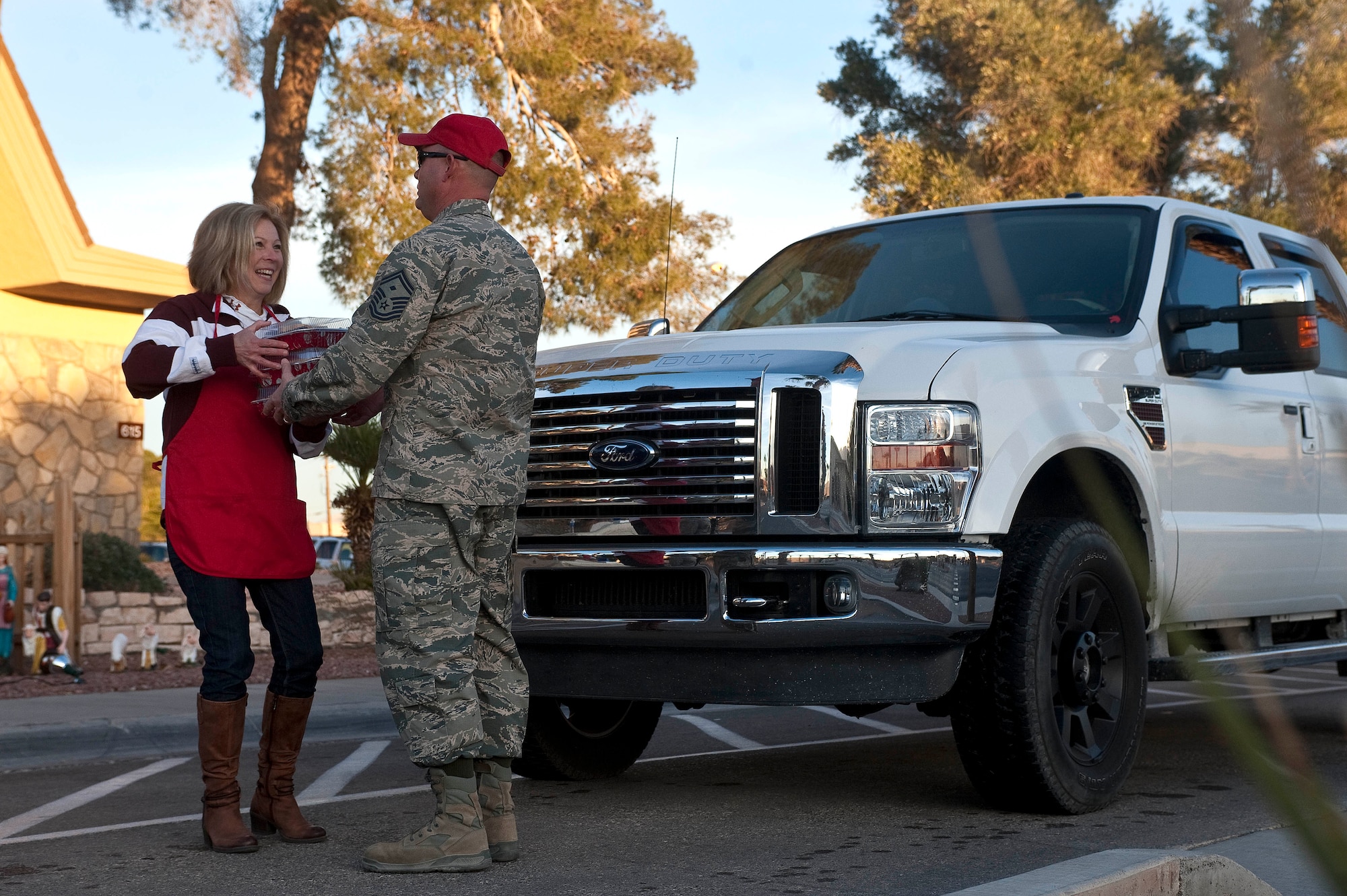 Stella Buck, senior-leader spouse, collects cookies for the Cookie Drive Dec. 11, 2012, at Nellis Air Force Base, Nev. Cookies are collected for the drive to be handed out to Airmen who live in the dormitories. (U.S. Air Force photo by Staff Sgt. Christopher Hubenthal)
