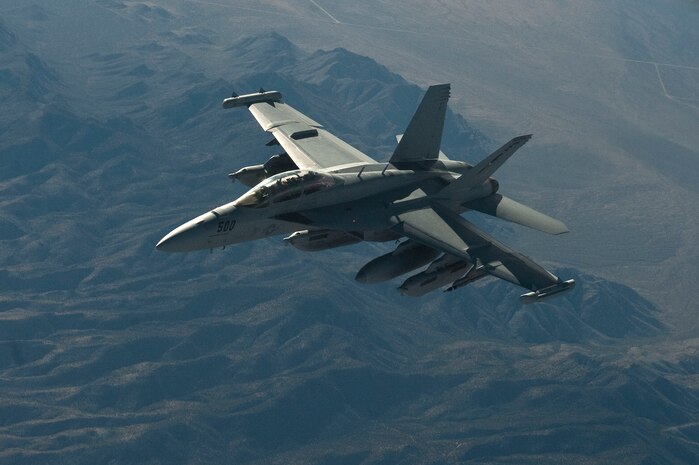 A U.S. Navy F-18 Hornet of the Naval Strike and Air Warfare Center, participates in the Mission Employment Phase exercise Dec. 9, 2012, over the Nevada Test and Training Range. The exercise is hosted north of Las Vegas on the NTTR--the U.S. Air Force's premier military training area with more than 12,000 square miles of airspace and 2.9 million acres of land. (U.S. Air Force photo by Staff Sgt. Christopher Hubenthal)