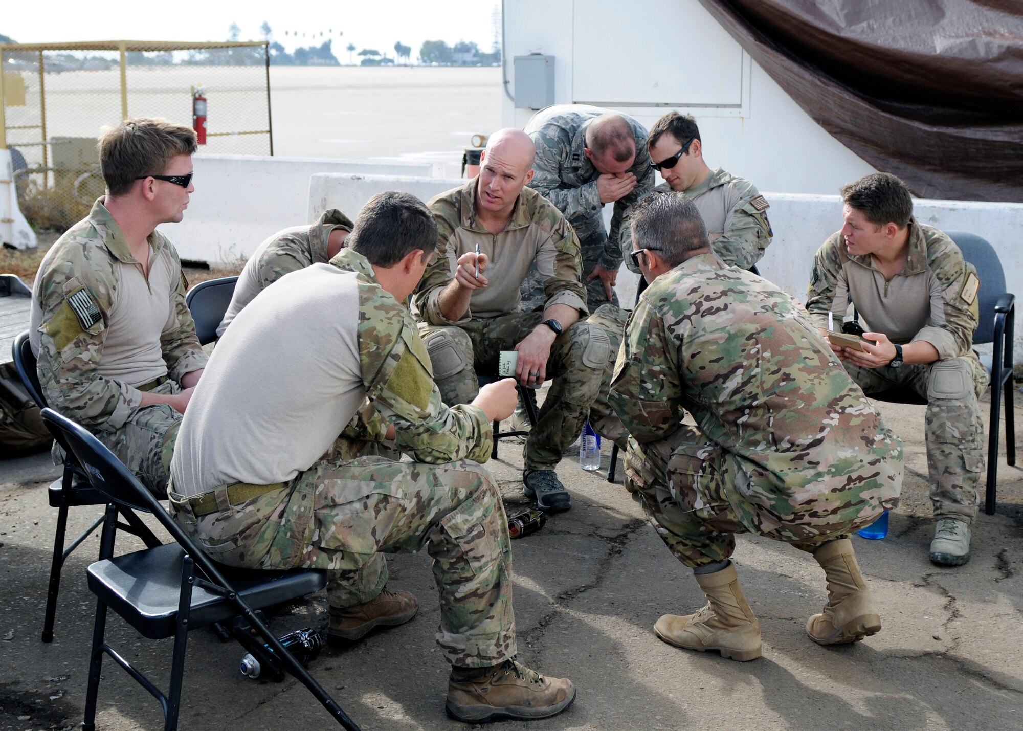 U.S. Air Force pararescuemen debrief after a simulated personnel recovery operation as part of Joint Task Force Exercise with the Navy on Naval Air Station North Island. The operation is the first time Air Force rescue forces have participated in a JTFEX and are directly supporting tactics, techniques and procedures for Air-Sea Battle as it relates to personnel recovery. (U.S. Navy photo by Mass Communication 3rd Class John Grandin/RELEASED)  