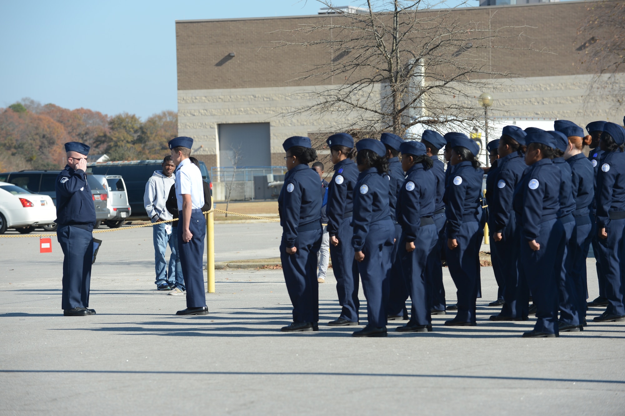Master Sgt. Thomas Kime, 20th Logistics Readiness Squadron section chief of fuels distribution, salutes an Air Force Junior ROTC drill team during a drill competition at Sumter High School, S.C., Nov. 29, 2012. Kime and three other Airmen from Shaw Air Force Base, S.C., volunteered to judge the competition and provide feedback. (U.S. Air Force photo by Airman 1st Class Krystal M. Jeffers/Released)