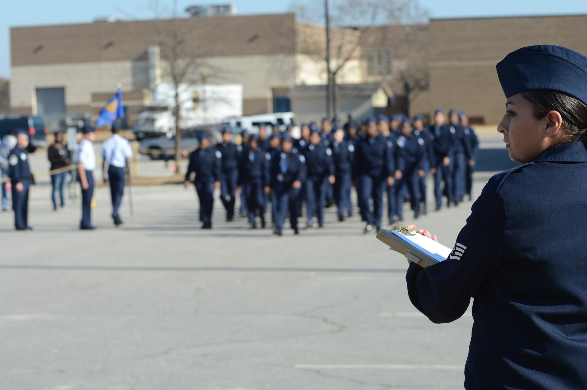 Staff Sgt. Julie Walker, U.S. Air Forces Central Command postal operations manager, and Master Sgt. Thomas Kime, 20th Logistics Readiness Squadron section chief of fuels distribution, judge an Air Force Junior ROTC drill competition at Sumter High School, S.C., Nov. 29, 2012. After the flights were judged, Walker and Kime spoke to each class about being in the military and answered cadets’ question. (U.S. Air Force photo by Airman 1st Class Krystal M. Jeffers/Released)