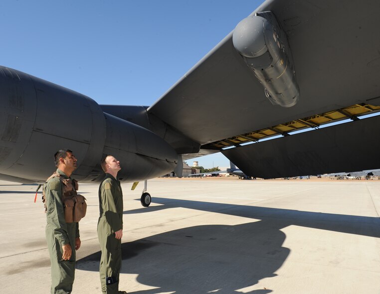 Sagar Pathak follows Capt. Jordan Filer, 2nd Operations Support Squadron aircraft commander, as he performs a preflight inspection of the LITENING advanced targeting pod on Barksdale Air Force Base, La., Dec. 11. Pathak is an associated editor for the national aviation magazine "In-flight USA" and received an opportunity to fly inside a B-52H Stratofortress. (U.S. Air Force photo/Airman 1st Class Benjamin Gonsier)
