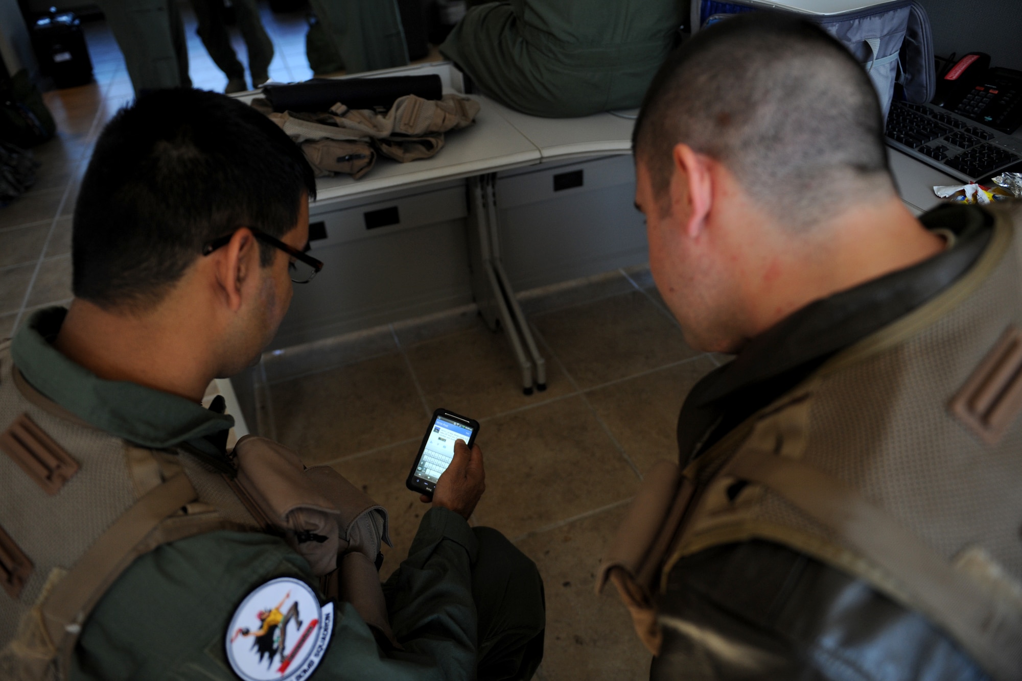Sagar Pathak looks at a tweet with 1st Lt. Justin Weaver, 20th Bomb Squadron navigator, on Barksdale Air Force Base, La., Dec. 11. Pathak is an associated editor for the national aviation magazine "In-flight USA" and received an opportunity to fly inside a B-52H Stratofortress. (U.S. Air Force photo/Airman 1st Class Benjamin Gonsier)
