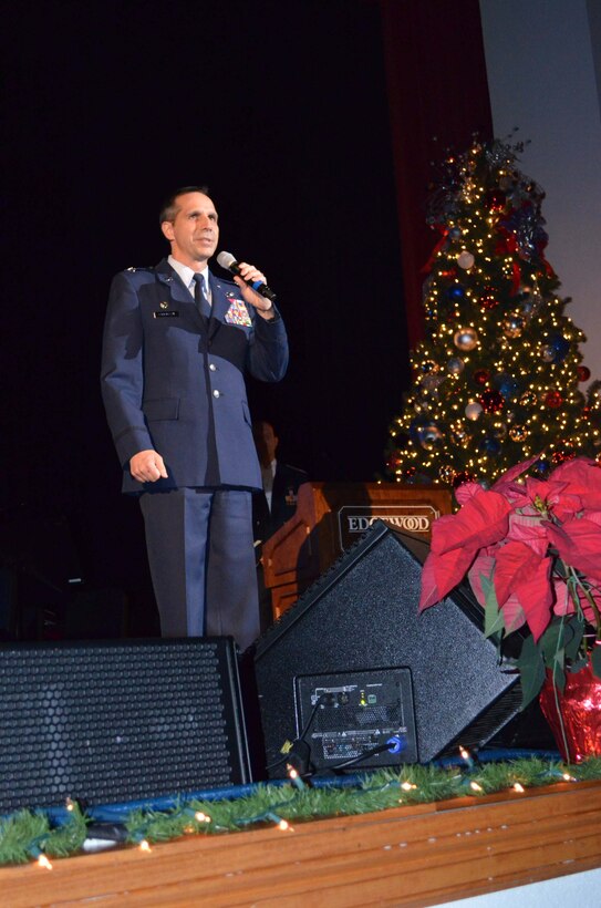 Col. Jeffrey T. Pennington, commander of the 433rd Airlift Wing, addresses the crowd at the Holiday in Blue concert featuring the U.S Air Force Band of the West at Edgewood Theater for the Performing Arts in San Antonio Dec. 9, 2012. The 433rd AW hosted the event complete with sing-a-longs, and a visit from Santa Claus. (U.S. Air Force photo by Maj. Tim Wade)