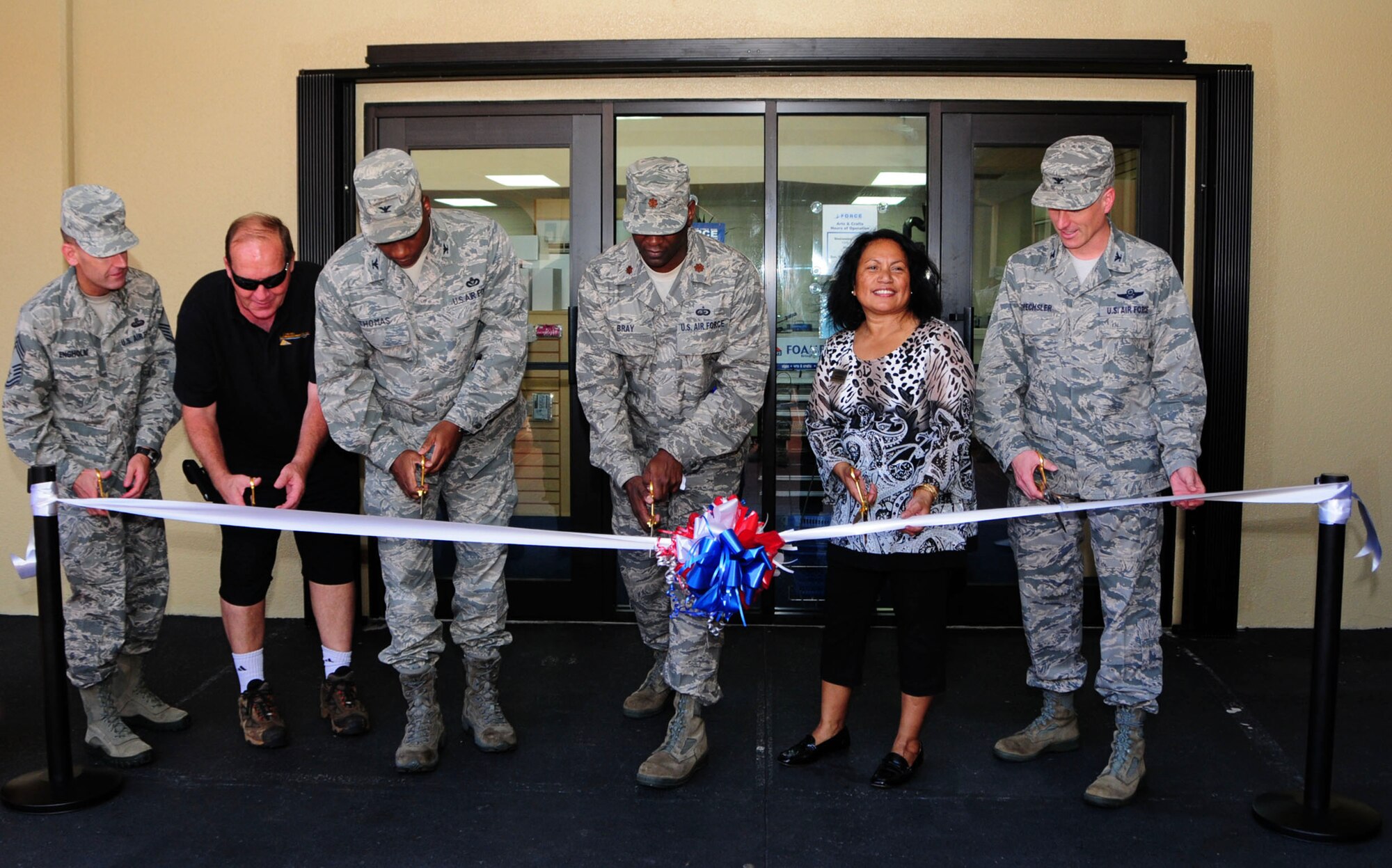 ANDERSEN AIR FORCE BASE, Guam -- Leadership from the 36th Wing and 36th Force Support Squadron personnel cut the ceremonial ribbon at the opening of the new Arts and Crafts Center on Andersen Air Force Base, Guam, Dec. 7, 2012. The store is now located in the Plaza Arcade across the Gecko Lanes bowling center. (U.S. Air Force photo/Airman 1st Class Marianique Santos/Released)