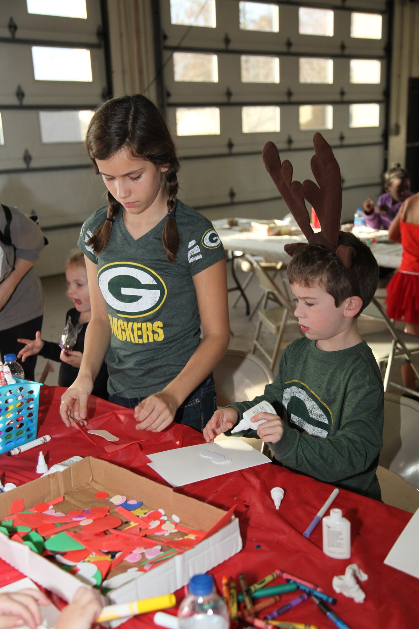 Lindsay and Sean Walter, daughter and son of Lt. Col. Terrence Walter, 20th Civil Engineer Squadron commander, finish one of many crafts at a children's holiday party.  The 20th Mission Support Group hosted a children's holiday party Dec. 9 at the Shaw AFB fire department.