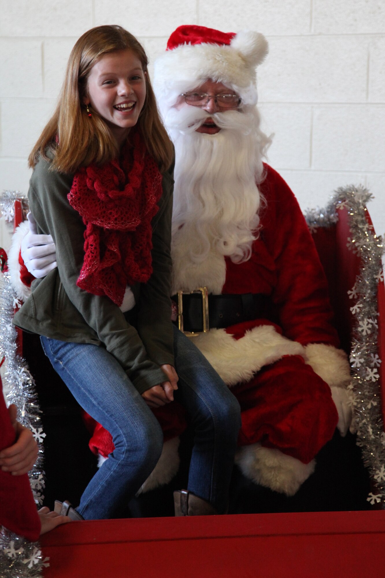 Elyse Snodgrass, daughter of Lt. Col. Robert Snodgrass, 20th Mission Support Group deputy commander, laughs with Santa at the base fire department.  The 20th Mission Support Group hosted a children's holiday party Dec. 9 at the Shaw AFB fire department.
