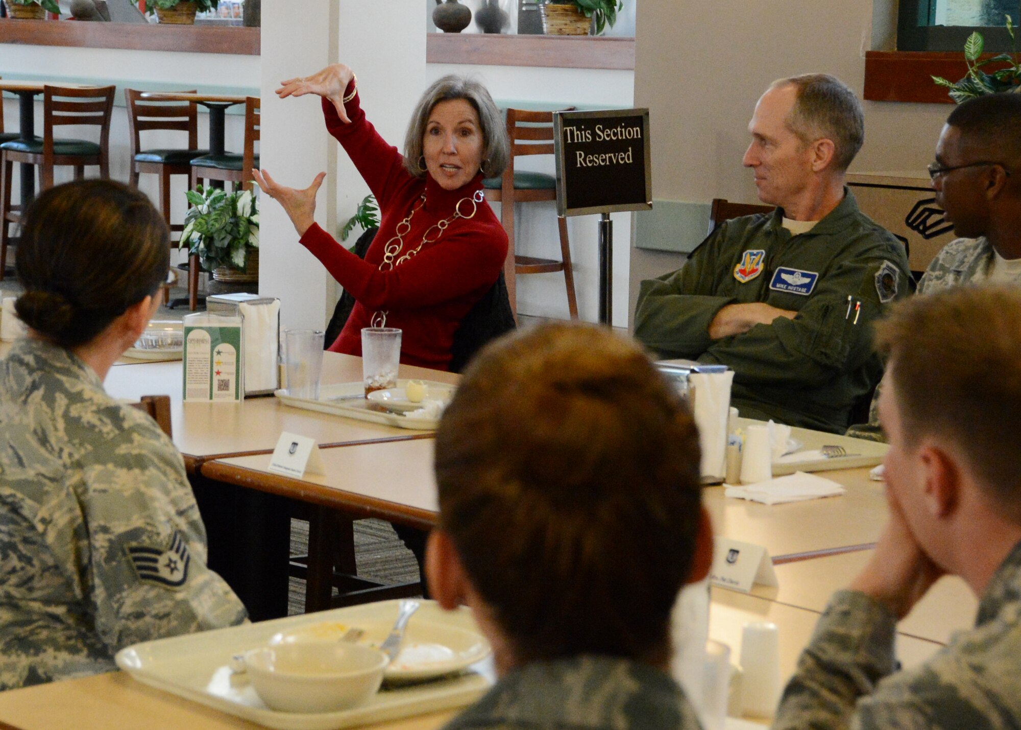 Kathy Hostage, wife of U.S. Air Force General Mike Hostage, Air Combat Command commander, speaks with an airman about post-deployment physical training programs at the chief Master Sgt. Emerson Williams Dining Facility December 7, 2012. Gen. Hostage attended the open forum breakfast to discuss topics on Airmen’s minds. (U.S. Air Force photo by Senior Airman Tabatha Zarrella/ Released)