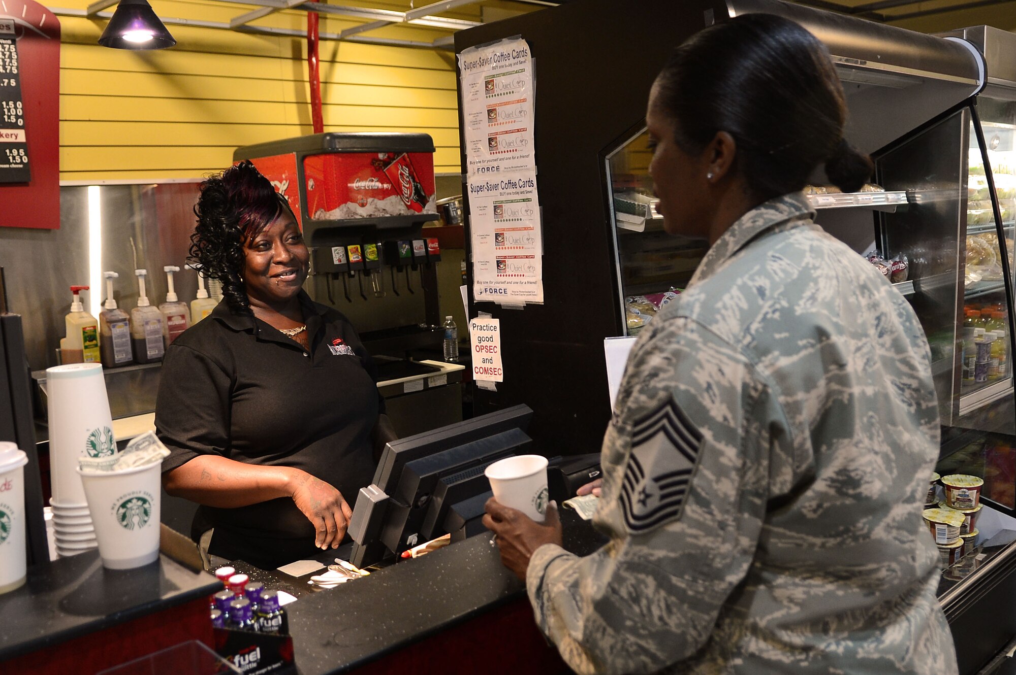 Latonya Ludd, Rickenbackers barista, (left) gives change to U.S. Air Force Chief Master Sgt. Juanita Osby, 20th Comptroller Squadron superintendent, at Shaw Air Force Base, S.C., Dec. 10, 2012. Ludd is the Shaw Spotlight for the week of Dec. 10 to Dec. 14. (U.S. Air Force photo by Airman Nicole Sikorski/Released)