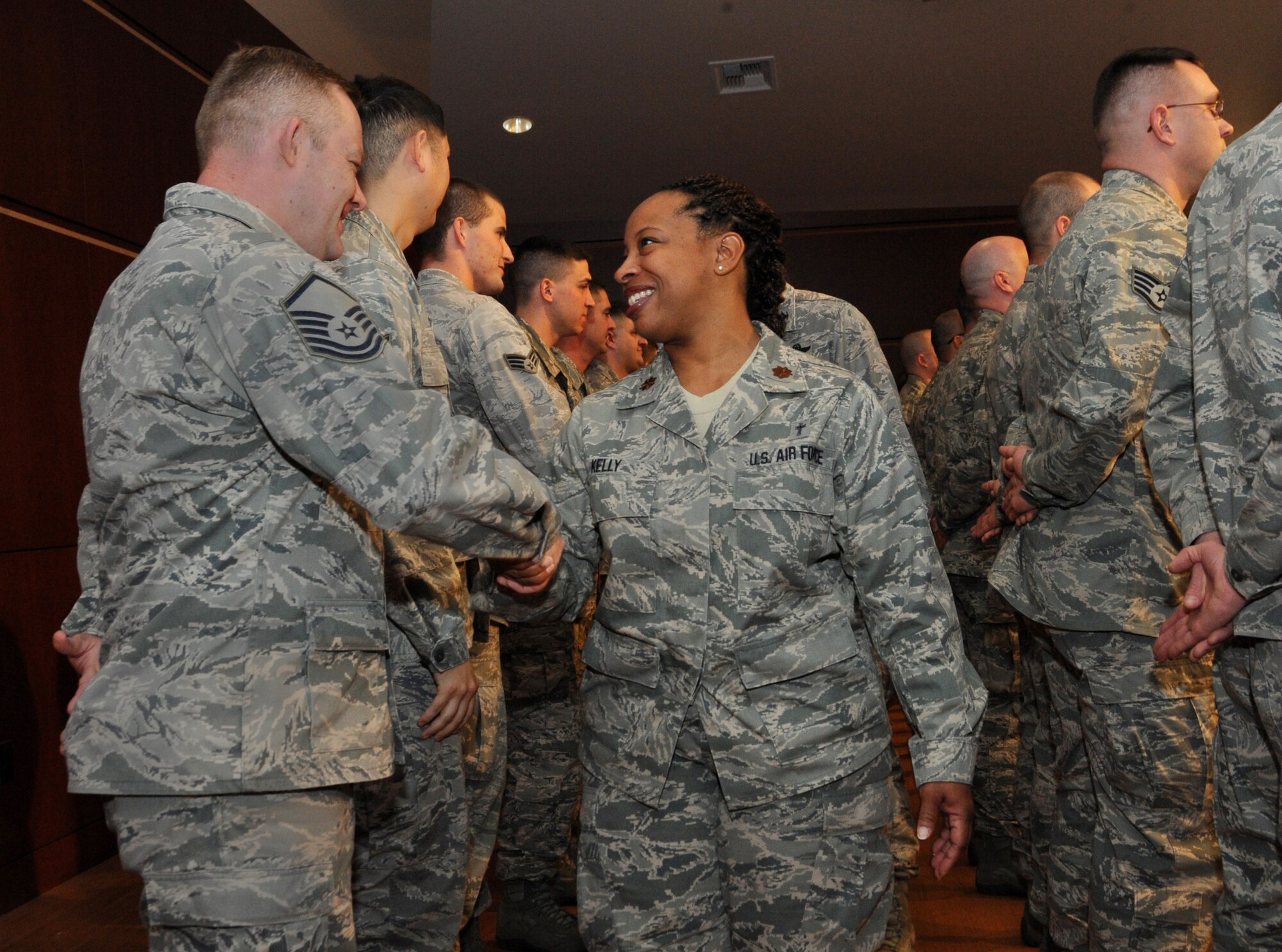 Oregon Air National Guard Chaplain Maj. Trisa Kelly shakes hands with deploying Oregon Air National Guard Master Sgt. Christopher Rich, 142nd Fighter Wing Security Forces Squadron during the mobilization ceremony for the 142nd Fighter Wing Security Forces Squadron at Camp Withycombe, Ore., Dec. 11, 2012. (U.S. Air Force photograph by Tech. Sgt. John Hughel, 142nd Fighter Wing Public Affairs/Released)