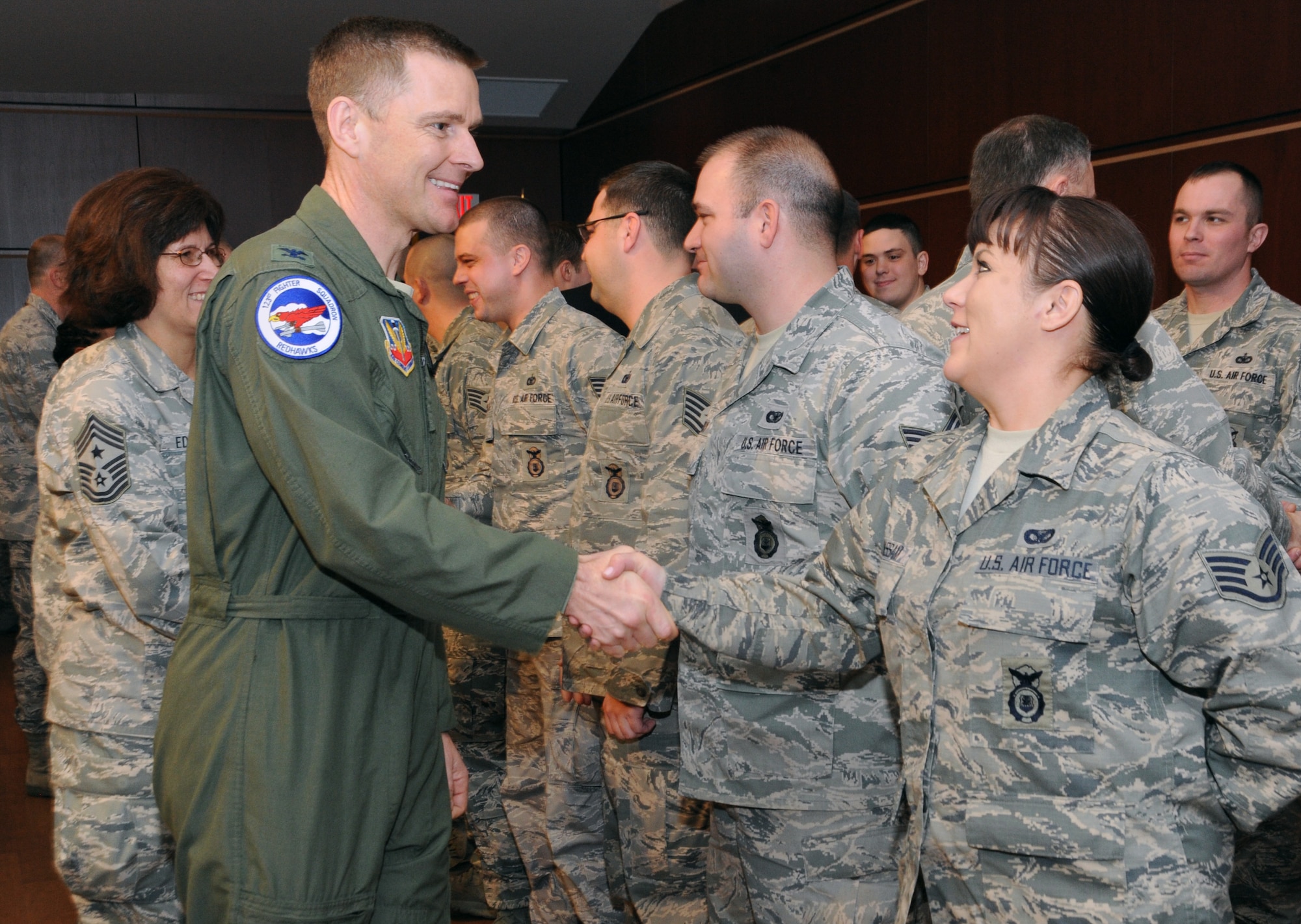 Oregon Air National Guard Col. Rick Wedan, 142nd Fighter Wing Commander shakes hands with Oregon Air National Guard Staff Sgt. Sara J. Wassam, 142nd Fighter Wing Security Forces Squadron during the mobilization ceremony for the 142nd Fighter Wing Security Forces Squadron at Camp Withycombe, Ore., Dec. 11, 2012. (U.S. Air Force photograph by Tech. Sgt. John Hughel, 142nd Fighter Wing Public Affairs/Released)