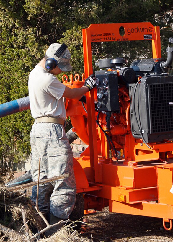 Senior Airman Miguel Barrenada, 11th Civil Engineer Squadron water and fuel systems maintenance journeyman, performs a systems check prior to pump operation Nov. 10, 2012 in Breezy Point, N.Y. Members of the 11th CES team deployed to N.Y., to provide assistance to Hurricane Sandy relief efforts. (U.S. Air Force photo/Tech. Sgt. Eddie White) 