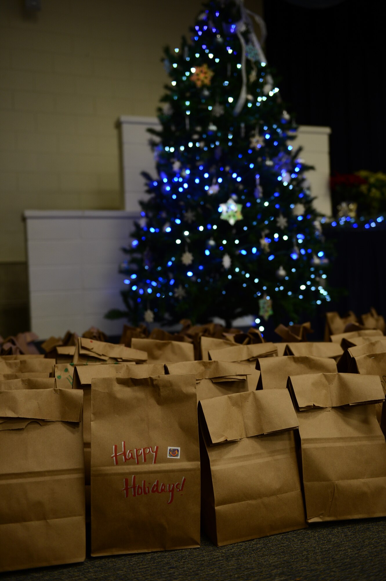 Bags of donated cookies gather under a Christmas tree during the cookie drive at Shaw Air Force Base, S.C., Dec. 5, 2012. Bags of cookies were given to Airmen who were living in the dorms for the holidays. More than 46,700 cookies were donated along with approximately 3,000 Christmas cards. (U.S. Air Force photo by Airman 1st Class Krystal M. Jeffers/Released)