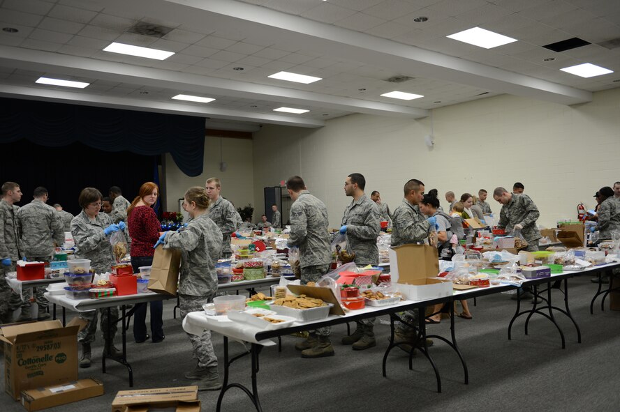 Team Shaw Airmen and spouses bag up donated cookies during the cookie drive at Shaw Air Force Base, S.C., Dec. 5, 2012. More than 46,700 cookies were donated, about 10,000 more than last year, were given to Airmen living in the dorms. (U.S. Air Force photo by Airman 1st Class Krystal M. Jeffers/Released)