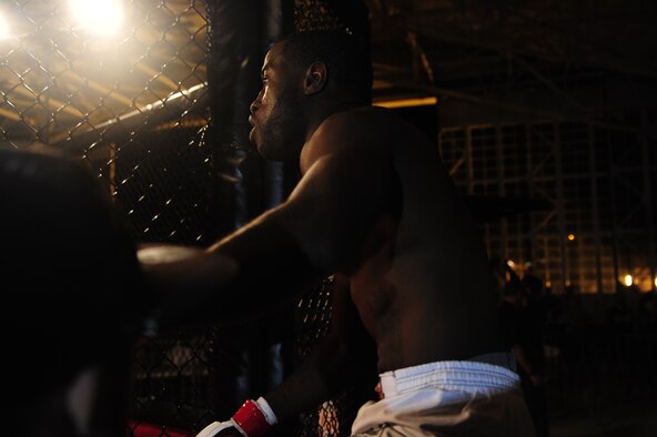 Staff Sgt. Steve Burks, an avionics Airman of 1st Special Operations Aircraft Maintenance Squadron, enters the octagon cage as part of the co-main event at Strike Fight at Hanger 102 on Eglin Air Force Base, Fla., Dec. 8.  Burks fought in the 145-pound division and sported an undefeated record of 10-0 amateur and 1-0 professional record.  (U.S. Air Force Photo / Airman 1st Class Benjamin D. Kim)