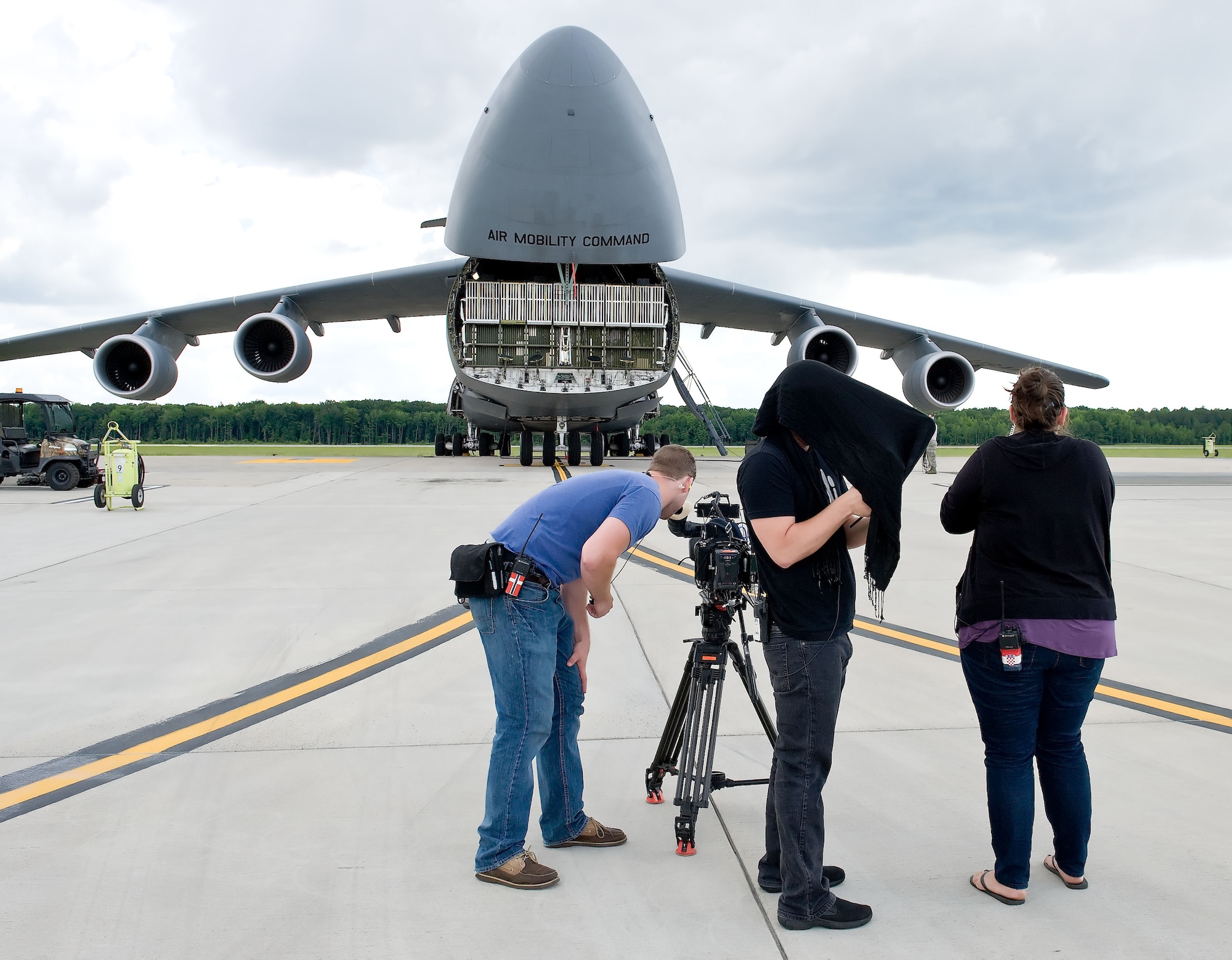 The ?Cake Boss? video crew records the opening of the visor on a C-5M Super Galaxy June 6, 2012, at Dover Air Force Base, Del. A special birthday cake was made by Buddy Valastro and his family at Carlo's Bakery in Hoboken, N.J., which is part of The Learning Channel's reality show "Cake Boss." The U.S. Air Force delivered the cake to U.S. Army personnel deployed to Afghanistan in time for the Army's 237th birthday June 14, 2012.  (U.S. Air Force photo/Roland Balik)