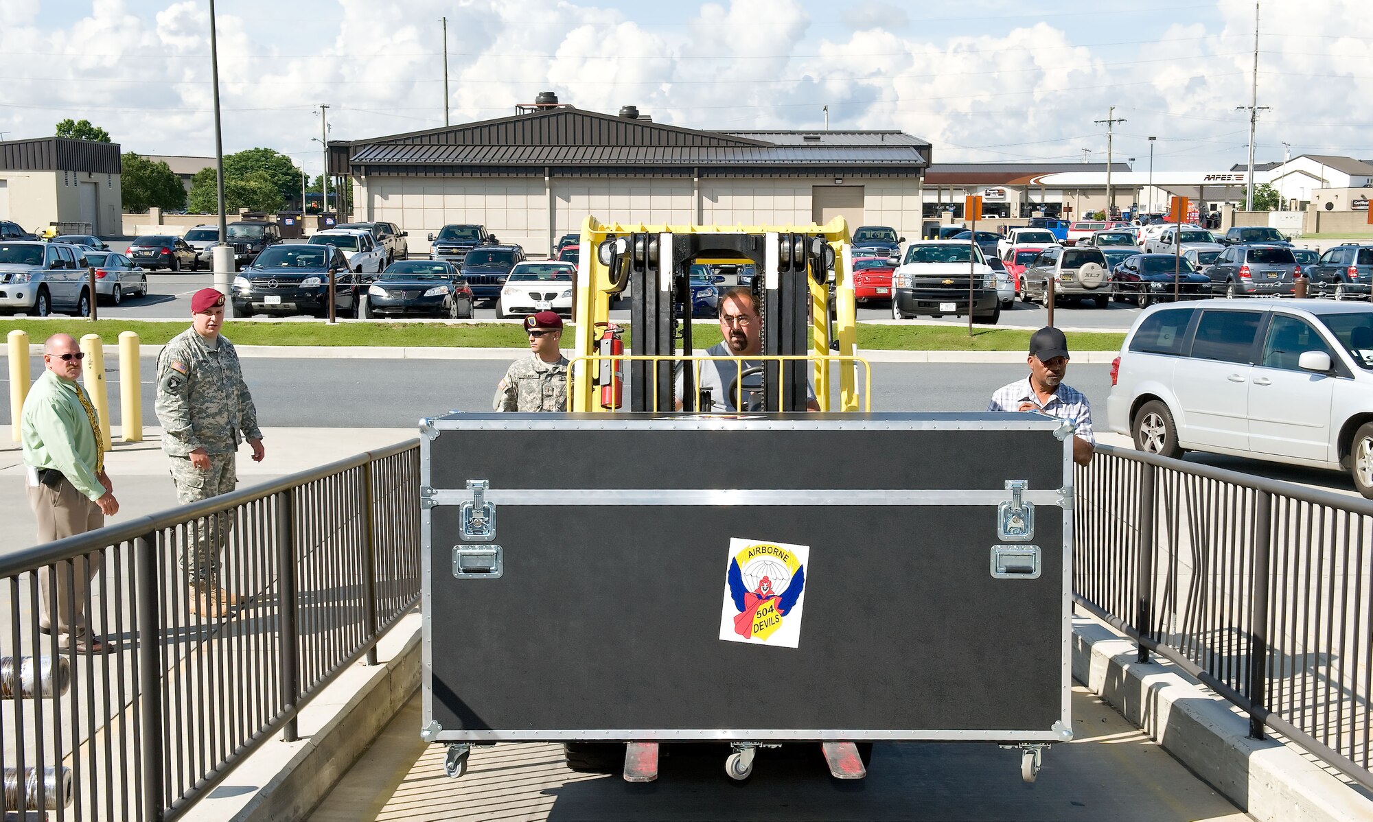 Joe Besherwor, a forklift operator with the 436th Aerial Port Squadron, delivers ?Cake Boss? and U.S. Army support supplies to the Super Port June 6, 2012, at Dover Air Force Base, Del. A special birthday cake for the U.S. Army was made by Buddy Valastro and his family at Carlo's Bakery in Hoboken, N.J., which is part of The Learning Channel's reality show "Cake Boss." The U.S. Air Force delivered the cake to Army personnel deployed to Afghanistan in time for the Army's 237th birthday June 14, 2012.  (U.S. Air Force photo/Roland Balik)