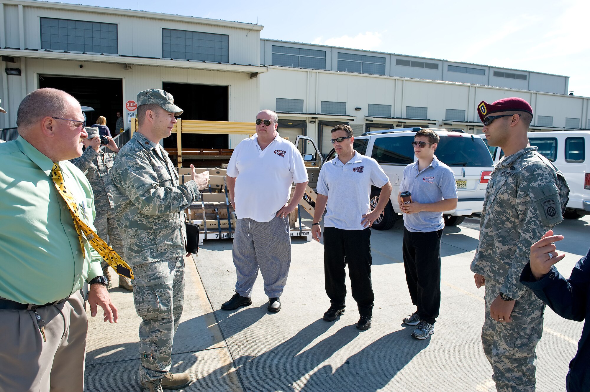 Members of the 436th Aerial Port Squadron meet with the ?Cake Boss? cast and U.S. Army personnel prior to videotaping the shipment of a special birthday cake June 6, 2012, at Dover Air Force Base, Del. The cake was made by Buddy Valastro and his family at Carlo's Bakery in Hoboken, N.J., which is part of The Learning Channel's reality show "Cake Boss." The U.S. Air Force delivered the cake to Army personnel deployed to Afghanistan in time for the Army's 237th birthday June 14, 2012.  (U.S. Air Force photo/Roland Balik)