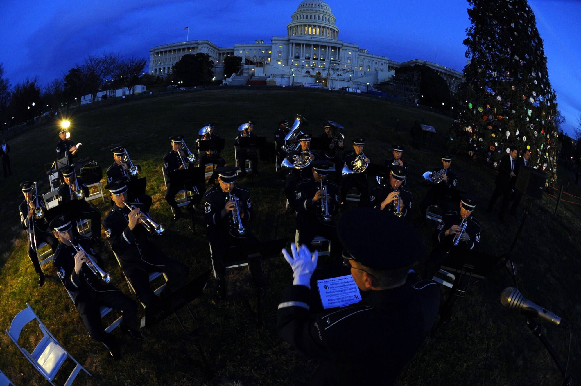 As dusk sweeps over the nation's capitol, members of the U.S. Air Force Air Force Band Ceremonial Brass play Christmas tunes for the Capitol Christmas Tree Lighting ceremony on the West Front Lawn Dec. 4, 2012.  The 73-foot-tall Engelmann Spruce is from the White River National Forest in Meeker, Colo. (U.S. Air Force photo/Staff Sgt. Torey Griffith)