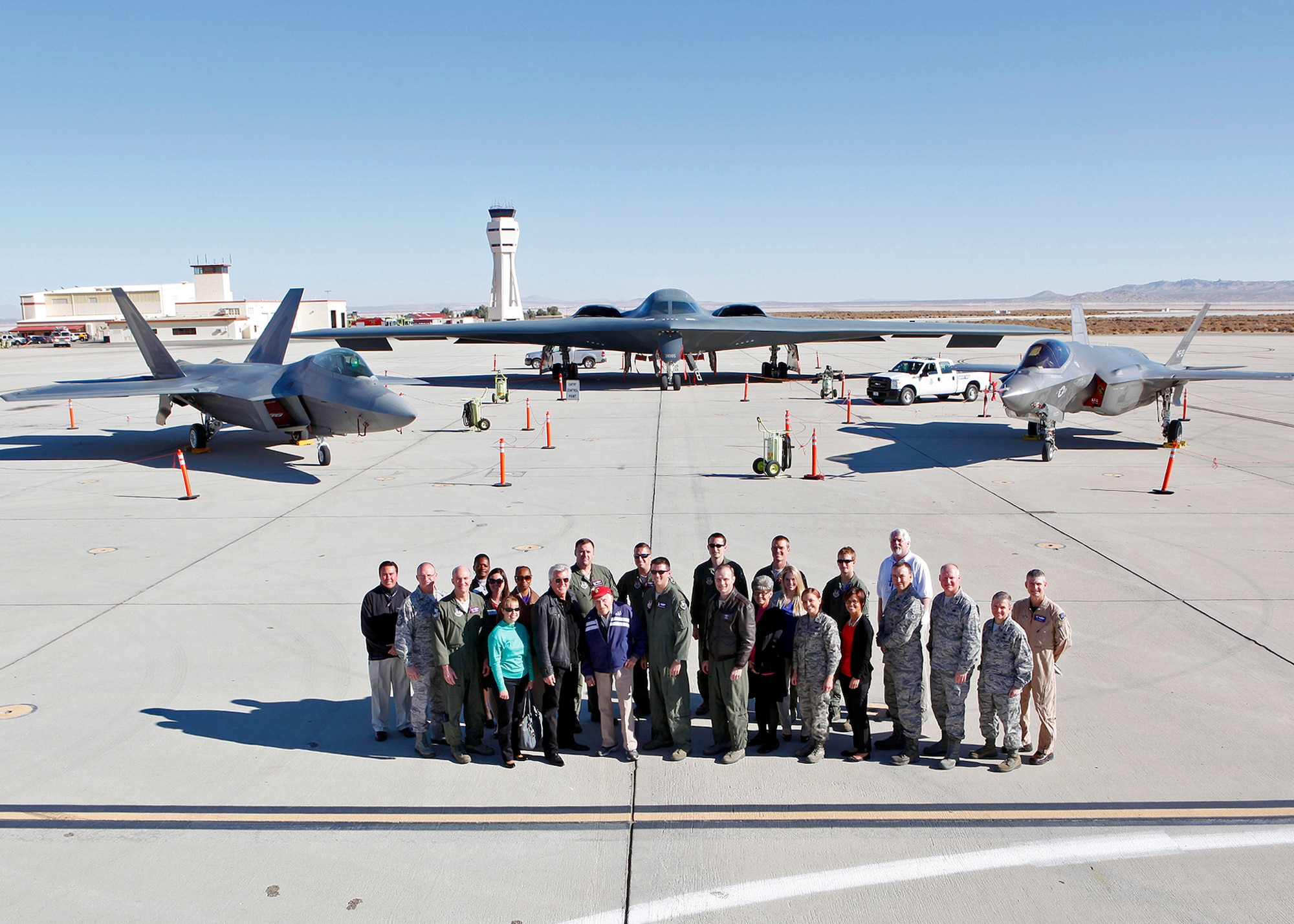 Members of Team Edwards got to pose for a photo with Louis Zamperini in front of a B-2 Spirit, an F-22 Raptor and an F-35 Lightning II Joint Strike Fighter Dec. 10. Afterwards, Zamperini spoke at the Base Theater for a training event on resiliency during Wingman Day. (U.S. Air Force photo by Jet Fabara)
