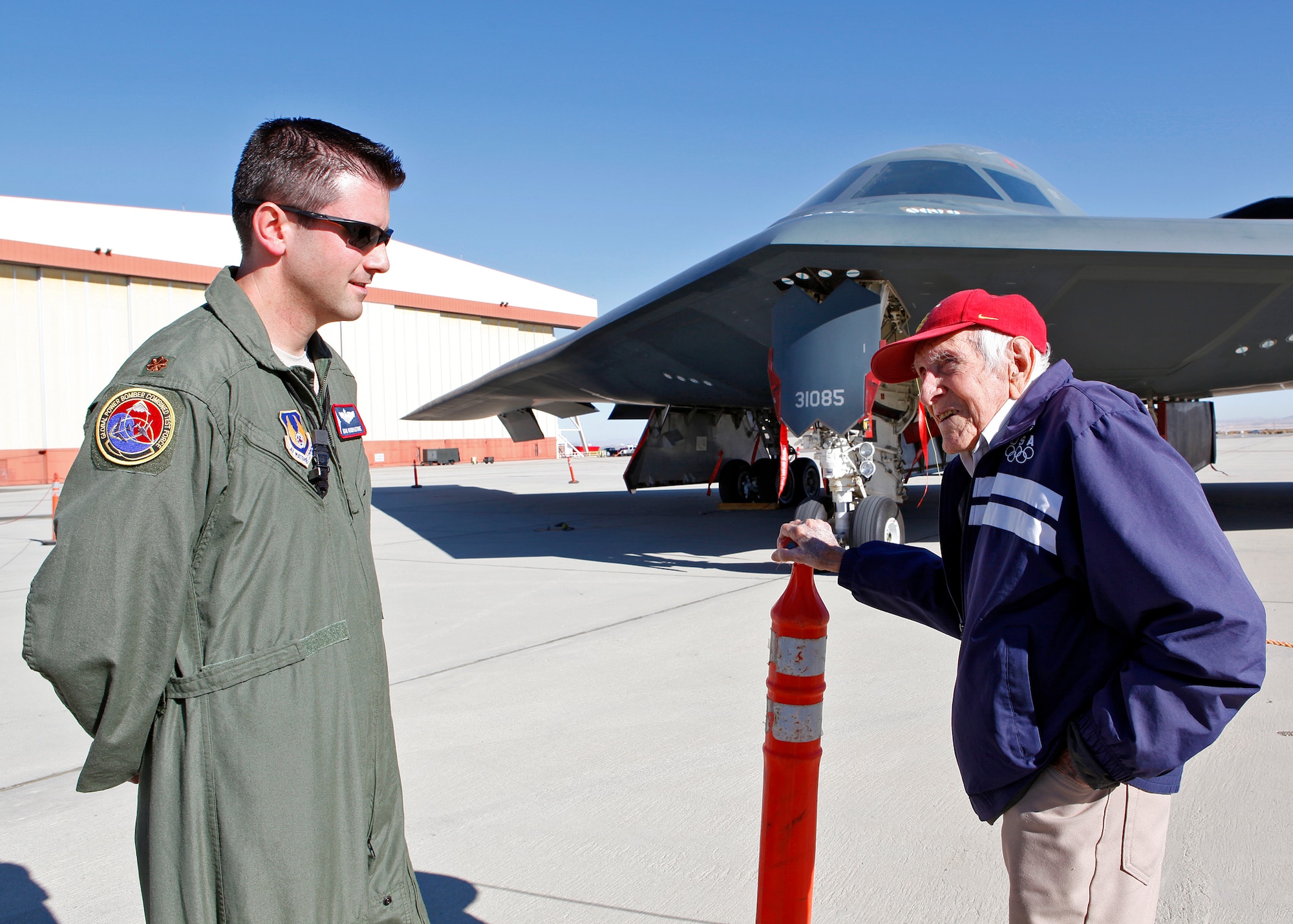 Maj. Adam Goodpasture, 419th Flight Test Squadron B-2 test pilot, speaks with Louis Zamperini who spoke to the Team Edwards community during Wingman Day Dec. 10, 2012, at the Base Theater. (U.S. Air Force photo by Jet Fabara)