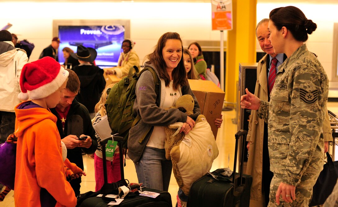 Joint Base Andrews Airmen help families carry their luggage after returning from a trip to Colorado at Ronald Reagan Washington National Airport, Washington, D.C., Dec. 4, 2012. The mission of Snowball Express is to Honor America’s fallen military service members who have made the ultimate sacrifice since Sept. 11, 2001 by humbly serving the families they left behind. (U.S. Air Force photo/ Airman 1st Class Erin O'Shea)