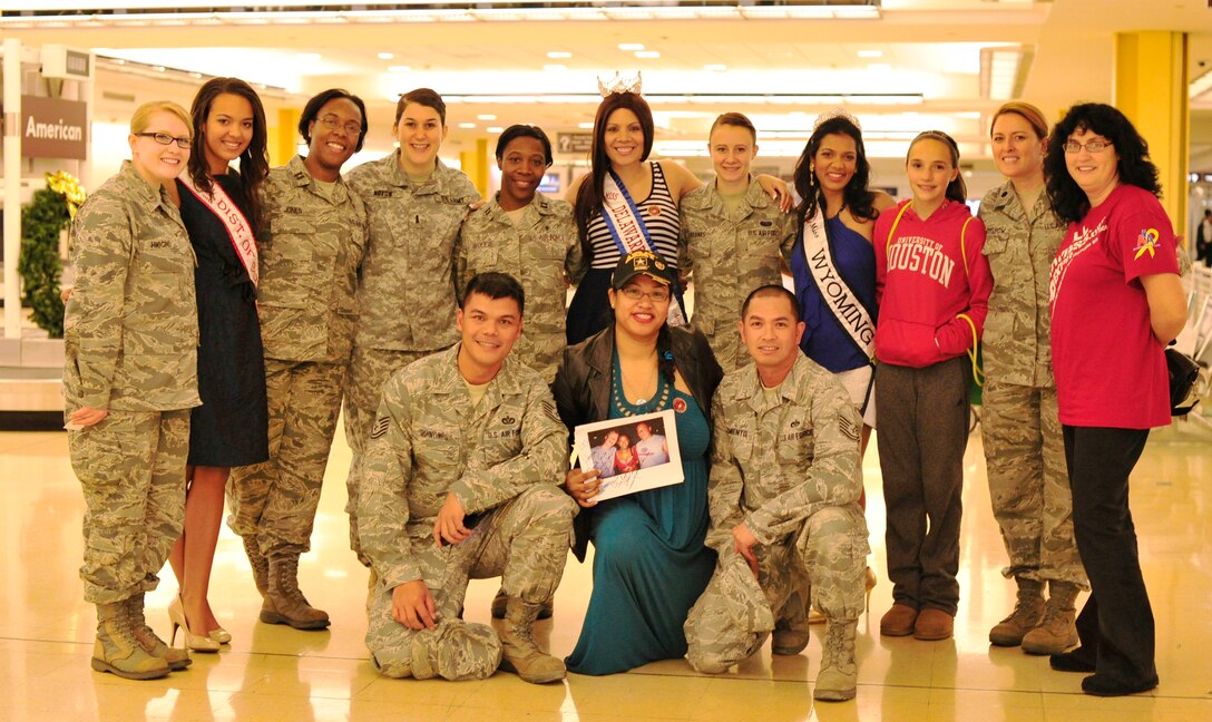 Joint Base Andrews Airmen stand with U.S. pageant winners, Maura Deegan, Miss District of Columbia Teen;  Elyse Millan, Miss Delaware Collegiate Teen; and Mary David, Miss Wyoming, during the Snowball Express homecoming  at Ronald Reagan Washington National Airport, Washington, D.C., Dec. 4, 2012. The mission of Snowball Express is to Honor America’s fallen military service members who have made the ultimate sacrifice since Sept. 11, 2001 by humbly serving the families they left behind. (U.S. Air Force photo/ Airman 1st Class Erin O’Shea)  
