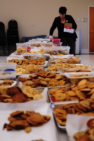 Ruth Ruffin, Team Charleston Spouses Club member, places cookies in a box during the Annual Cookie Drop Dec. 6, 2012, at the Joint Base Charleston - Air Base Chapel Annex. Operation cookie drop has been an Air Force tradition celebrated at bases around the world during the holiday season to show appreciation to war fighters overseas and young Airmen and Sailors living in the dorms, who are unable to be with their families during the holidays. This year’s Cookie Drop collected more than 500 boxes of homemade treats for dorm residents and enough treats to ship overseas for 140 deployed Airmen from JB Charleston. (U.S. Air Force photo/ Airman 1st Class Chacarra Walker)