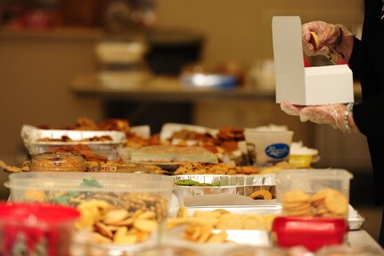 Ruth Ruffin, Team Charleston Spouses Club member, places cookies in a box during the Annual Cookie Drop Dec. 6, 2012, at the Joint Base Charleston - Air Base Chapel Annex. Operation cookie drop has been an Air Force tradition celebrated at bases around the world during the holiday season to show appreciation to war fighters overseas and young Airmen and Sailors living in the dorms, who are unable to be with their families during the holidays. This year’s Cookie Drop collected more than 500 boxes of homemade treats for dorm residents and enough treats to ship overseas for 140 deployed Airmen from JB Charleston. (U.S. Air Force photo/ Airman 1st Class Chacarra Walker)