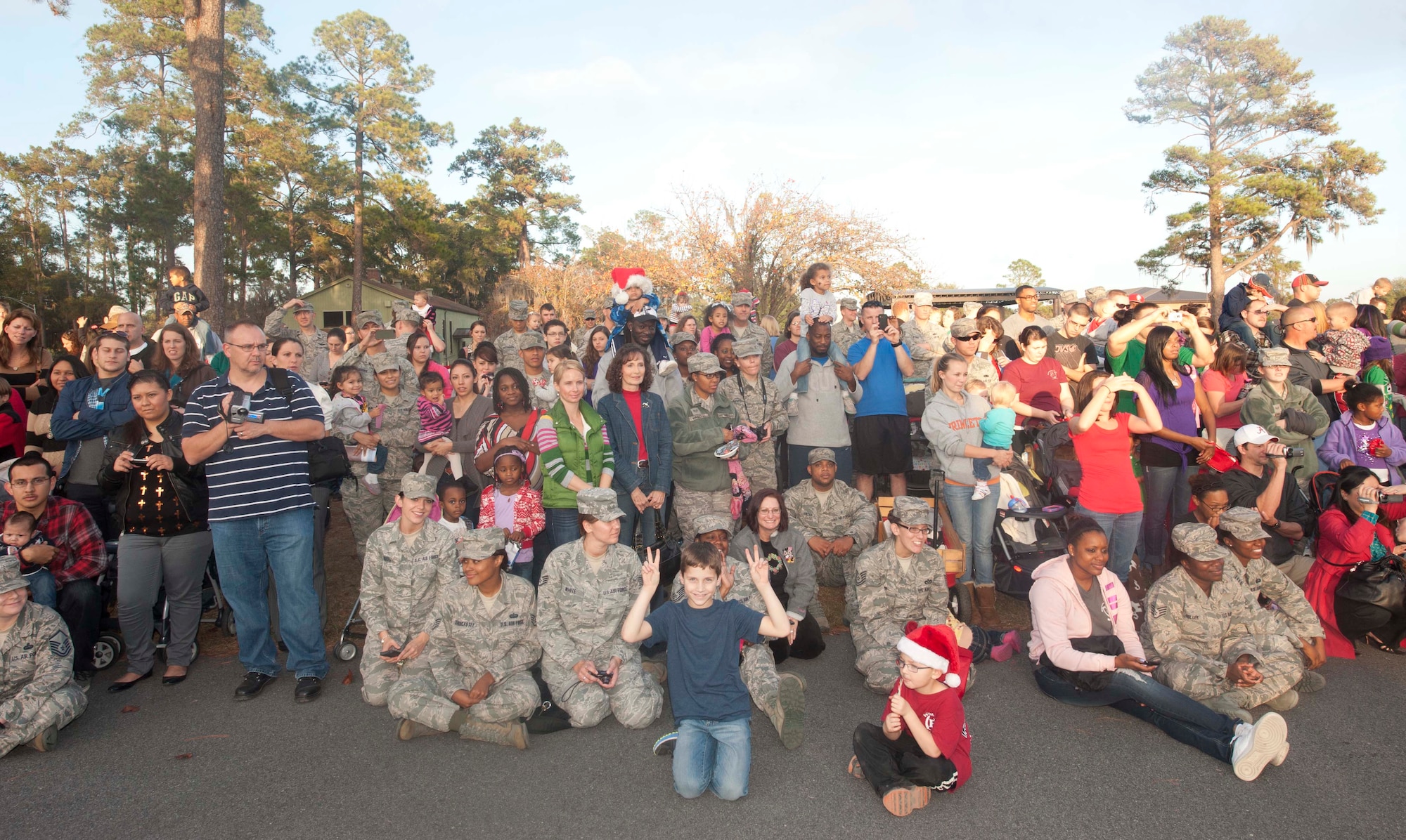 U.S. Air Force Airmen and family members gather at Moody Air Force Base Ga., for the Annual Base Tree Lighting and Holiday Parade on Dec. 7, 2012. Family members watched as children from the Child Development Center sang Christmas carols as part of the ceremony. (U.S. Air Force photo by Airman Paul Francis/Released)

