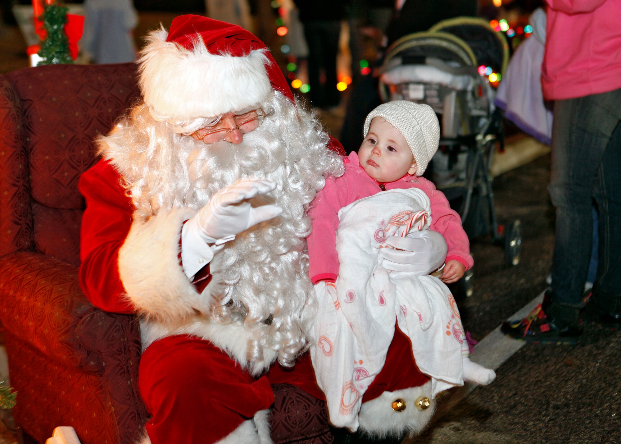 Arabella poses with Santa Claus during the annual holiday tree lighting ceremony held Dec. 7. The event was hosted by the 412th Force Support Squadron. (U.S. Air Force photo by Jet Fabara)