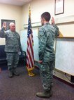 MINOT AIR FORCE BASE, N.D. -- 5th Medical Group commander, Col. William Tyra, gives the Oath of Office to Airman 1st Class Scott Nicol Dec. 10. Nicol was commissioned through the Medical Service Corps. His Commissioned Officer Training will begin Jan. 8 and afterward he will be assigned to Joint Base Lewis-McChord, Wash. (Courtesy photo) 