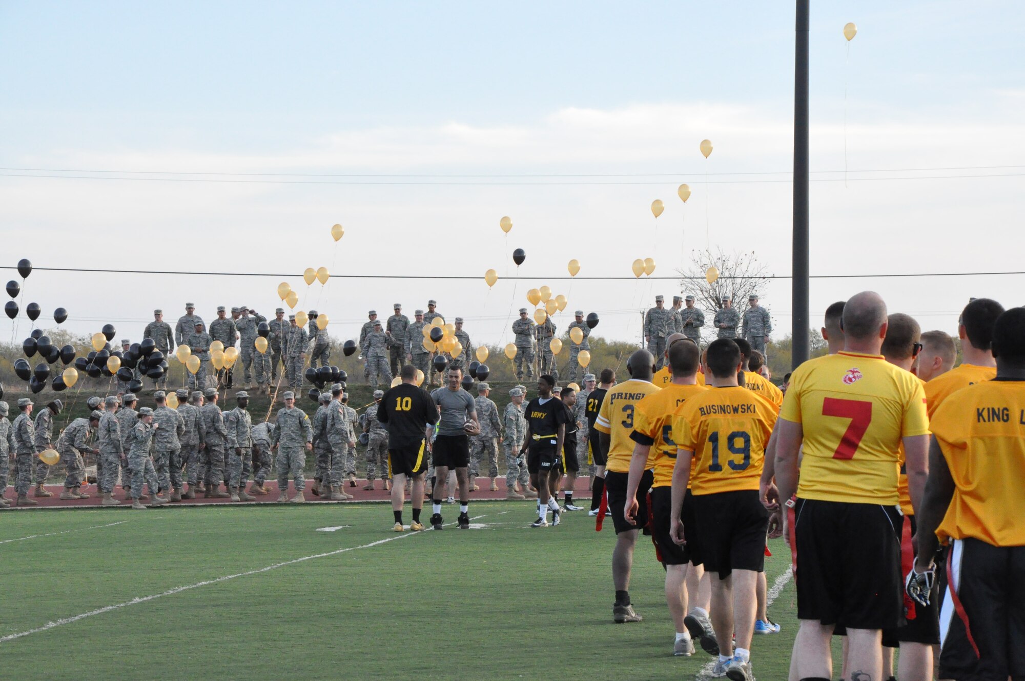 GOODFELLOW AIR FORCE BASE, Texas – The Army and Navy flag-football teams line up to shake hands at the end of the Goodfellow Air Force Base annual Army versus Navy flag football game at the Mathis Fitness Center football field here Dec. 7. The Army released 100 balloons to celebrate their victory over the Navy. (U.S. Air Force photo/ Airman 1st Class Joshua Edwards)