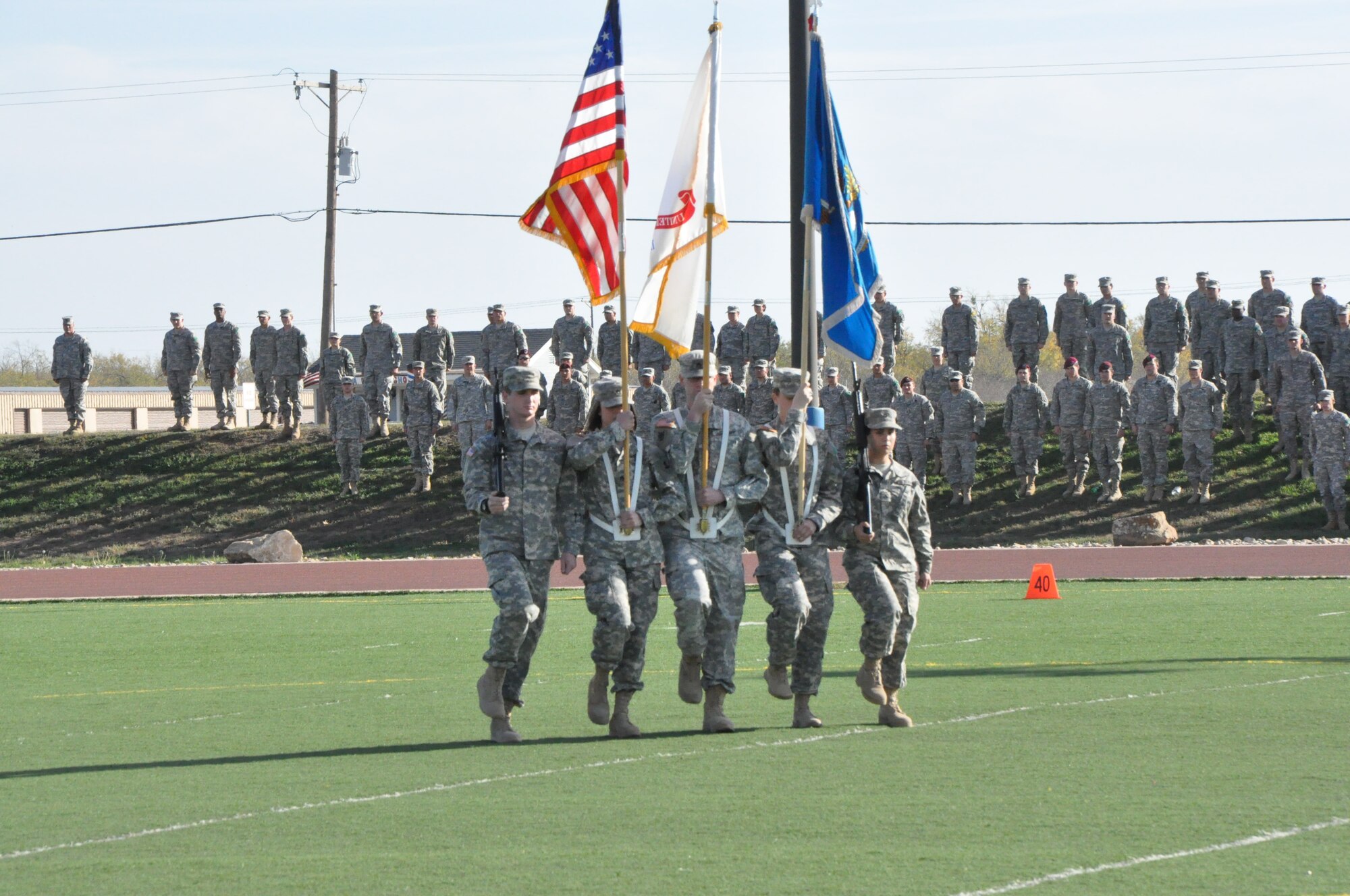 GOODFFELLOW AIR FORCE BASE, Texas – The Army Color Guard marches to the center of the football field near the Mathis Fitness Center before the start of the Goodfellow Air Force Base annual Army versus Navy flag-football game Dec. 7. The Army Color Guard then presented arms during the singing of the National Anthem. (U.S. Air Force photo/ Airman 1st Class Joshua Edwards)