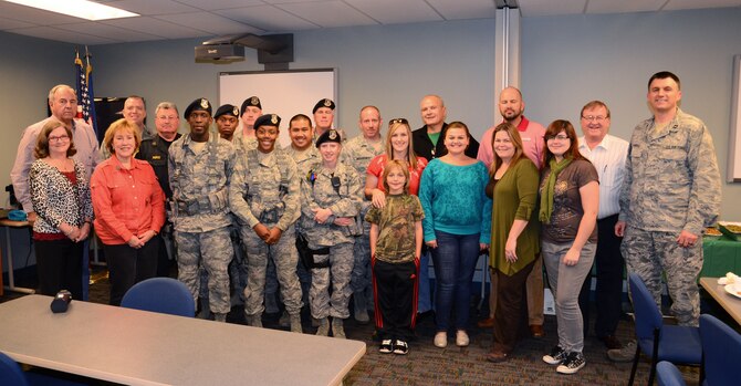 Members of the 94th Security Forces Squadron and some of the 94th Airlift Wing Honorary Commanders who provided a Thanksgiving meal get together for a picture at Dobbins Air Reserve Base, Nov. 21.   The 16 members of the wing’s honorary commanders group provided the meal for the men and women of the 94th SFS to say thank you for all that they do.  (U.S. Air Force photo/Brad Fallin)