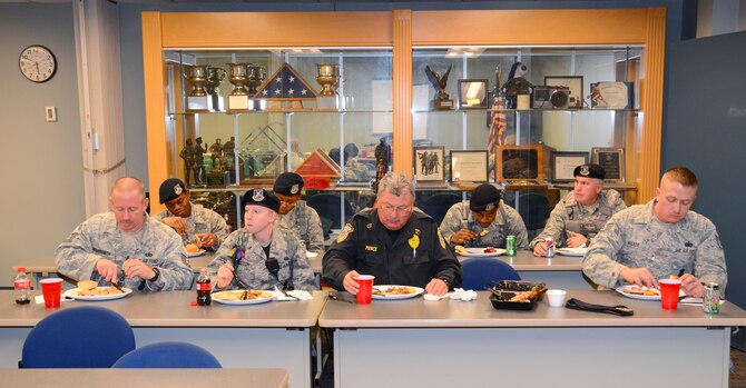 Members of the 94th Security Forces Squadron dig into a Thanksgiving feast provided by the Honorary Commanders of the 94th Airlift Wing at Dobbins Air Reserve Base, Nov. 21.   The 16 members of the wing’s honorary commanders group provided the meal for the men and women of the 94th SFS to say thank you for all that they do.  (U.S. Air Force photo/Brad Fallin)