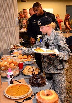 Staff Sgt. Kristi Huston and Officer Edward Savage make their way down the buffet line provided by the Honorary Commanders of the 94th Airlift Wing at Dobbins Air Reserve Base, Nov. 21.   The 16 members of the wing’s honorary commanders group provided this feast for the men and women of the 94th Security Forces Squadron to say thank you for all that they do.  (U.S. Air Force photo/Brad Fallin)