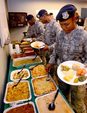 Airman 1st Class Shondrica Brooks and fellow Security Forces Airmen make their way down the buffet line provided by the Honorary Commanders of the 94th Airlift Wing at Dobbins Air Reserve Base, Nov. 21.   The 16 members of the wing’s honorary commanders group provided this feast for the men and women of the 94th Security Forces Squadron to say thank you for all that they do.  (U.S. Air Force photo/Brad Fallin)