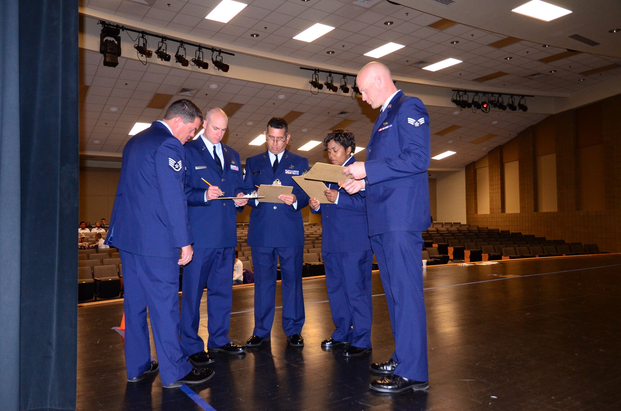 Volunteers from Dobbins Air Reserve Base compile scores after judging a local high school color guard at East Paulding High School, Nov. 3. The drill meet is the first in a series that local high school Junior ROTC programs and Dobbins Airmen will be involved with this year. (U.S. Air Force photo/Senior Airman Elizabeth Van Patten)
