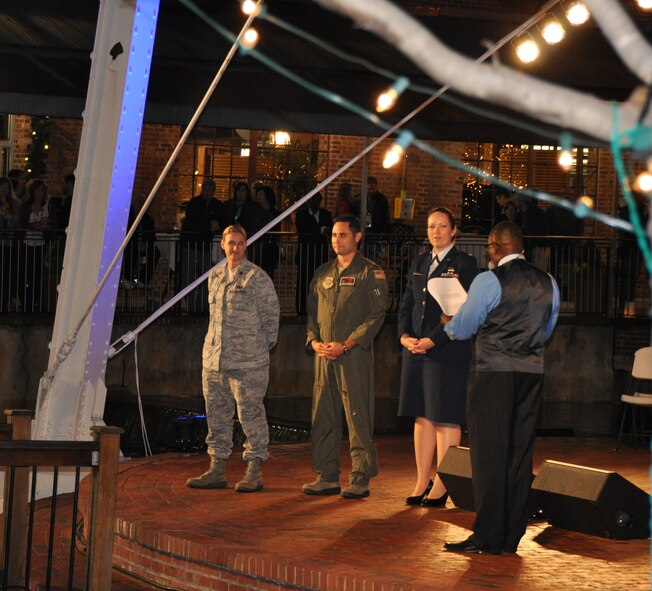 From left to right: Maj. Shannon Mann, 916th Public Affairs, Maj. Nate Rodriguez, 911th Air Refueling Squadron and Maj. Erin Karl, 916th Public Affairs help light the tower during the annual Durham Tower Lighting on Dec. 7, 2012. (USAF courtesy)