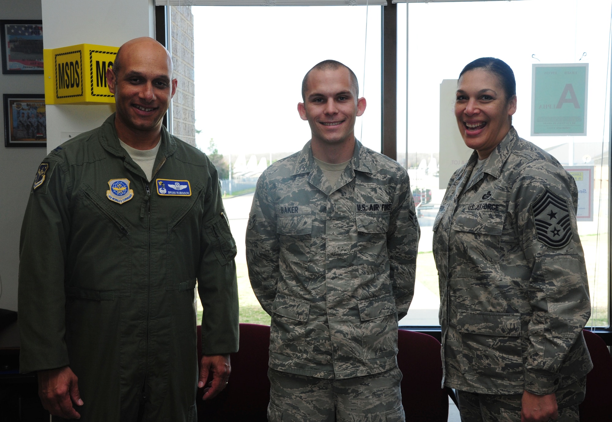 Col. Brian Robinson, 19th Airlift Wing commander, and Chief Master Sgt. Margarita Overton, 19th Airlift Wing command chief, congratulate Airman 1st Class Mark Baker for his selection as Combat Airlifter of the week Dec. 5, 2012 at Little Rock Air Force Base, Ark. Baker was twice awarded “Fuels Pumper of the Month” for his contributions to fueling the Team Little Rock combat airlift mission. (U.S. Air Force photo by Airman 1st Class Kaylee Clark)