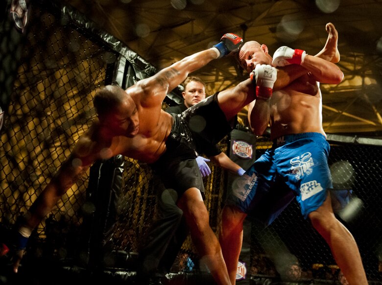 Danny Ruiz takes down William “The Slim Reaper” Kuhn during the mixed martial arts main event at Strike Fight Dec. 8 at Eglin Air Force Base, Fla.  Ruiz, an Air Force Reserve staff sergeant with the 919th Special Operations Wing, won by unanimous decision in one of 11 matches held at the base’s first-ever MMA event.  The debut event drew approximately 775 people.  (U.S. Air Force photo/Samuel King Jr.)