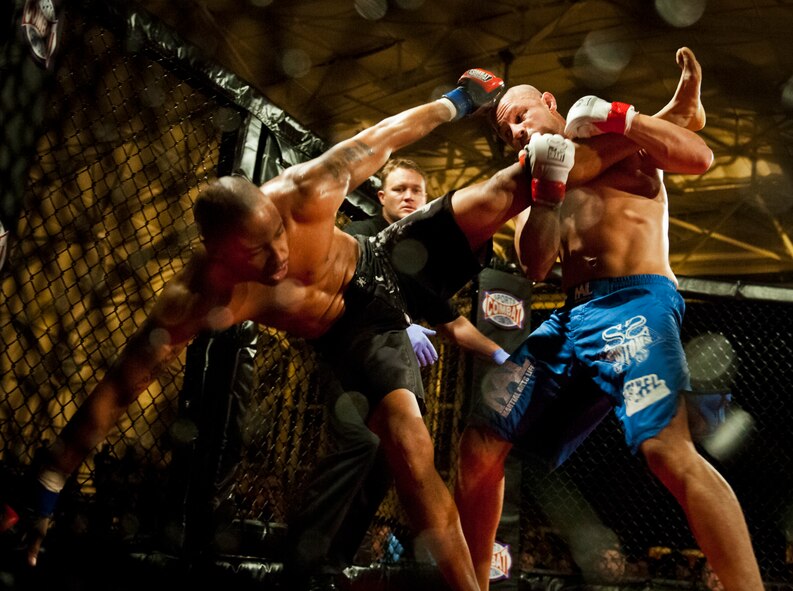 Danny Ruiz takes down William “The Slim Reaper” Kuhn during the mixed martial arts main event at Strike Fight Dec. 8 at Eglin Air Force Base, Fla.  Ruiz, an Air Force Reserve staff sergeant with the 919th Special Operations Wing, won by unanimous decision in one of 11 matches held at the base’s first-ever MMA event.  The debut event drew approximately 775 people.  (U.S. Air Force photo/Samuel King Jr.)