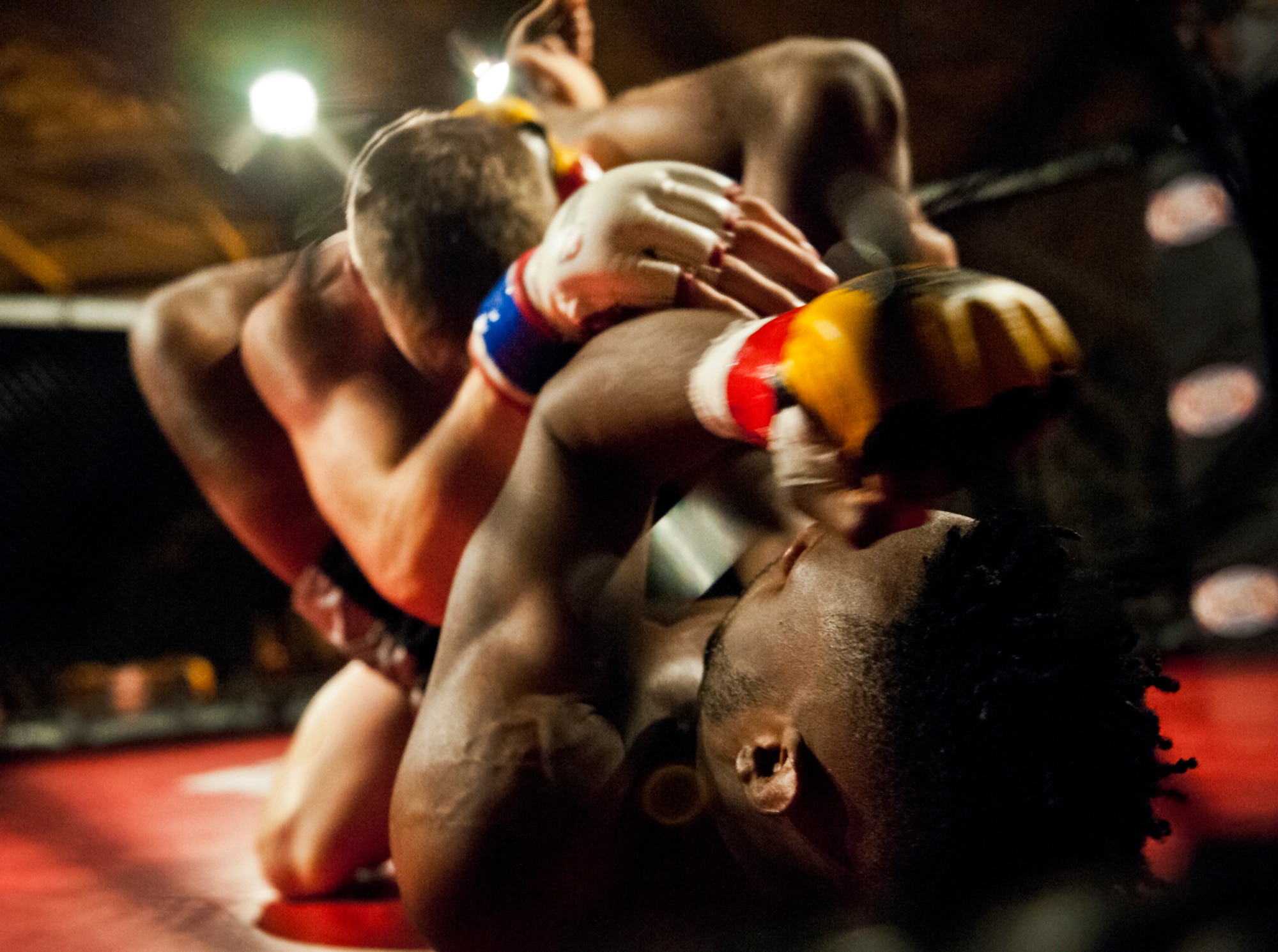 Martin Trey Brown tries to punch out of a hold by Thomas Gifford during their mixed martial arts bout at the Strike Fight event Dec. 8 at Eglin Air Force Base, Fla.  Brown won by a heel-hook submission in one of 11 matches held at the base’s first-ever MMA event that drew approximately 775 people.  (U.S. Air Force photo/Samuel King Jr.)